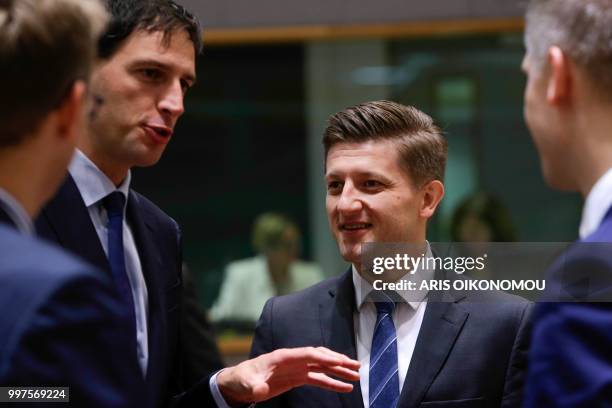 Dutch Finance Minister Wopke Hoekstra and Croatian Finance Minister Zdravko Maric speak with others during an Economic and Financial Affairs Council...