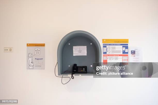 July 2018, Netherlands, Ter Apel: Information sheets stuck on a wall next to a telephone at the main reception centre for asylum seekers. Photo:...