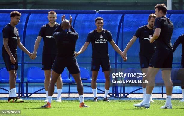 England's midfielder Dele Alli, England's midfielder Eric Dier, England's defender Trent Alexander-Arnold and England's forward Harry Kane take part...