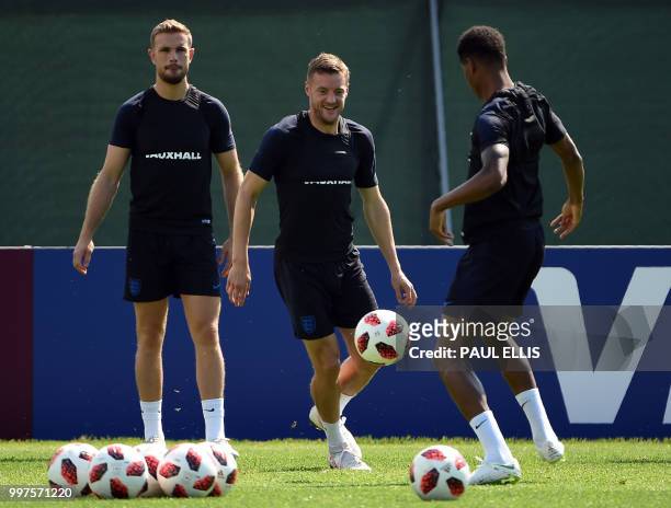 England's midfielder Jordan Henderson, England's forward Jamie Vardy and England's forward Marcus Rashford take part in a training session in Repino...
