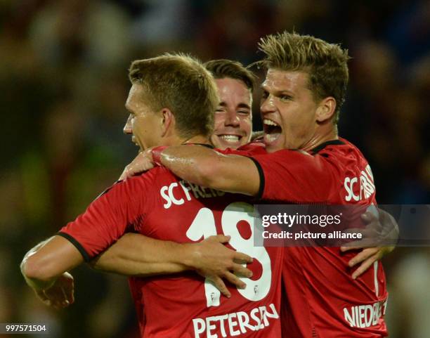 Nils Petersen, Christian Guenter and Florian Niederlechner of Freiburg celebrate the goal at 1:0 during the Europa League qualifier between SC...