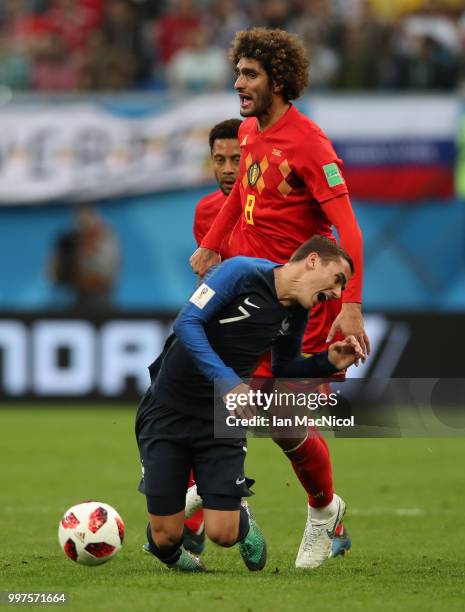 Marouane Fellaini of Belgium vies with Antoine Griezmann of France during the 2018 FIFA World Cup Russia Semi Final match between Belgium and France...