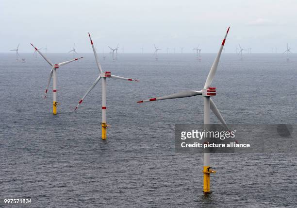 The offshore wind park "Nordsee 1" can be seen in front of the East Frisian island Spiekeroog, Germany, 27 July 2017. At this moment roughly half of...