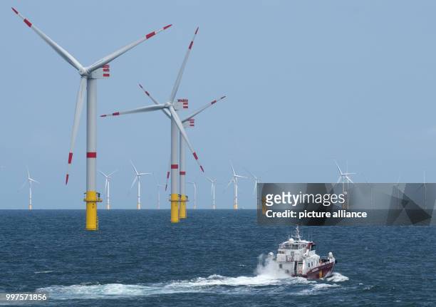The boat "Detector" drives through the offshore wind park "Nordsee 1" in front of the East Frisian island Spiekeroog, Germany, 27 July 2017. At this...