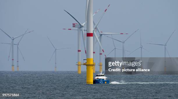 The service ship "Windea Four" sails through the offshore wind park "Nordsee 1" in front of the East Frisian island Spiekeroog, Germany, 27 July...