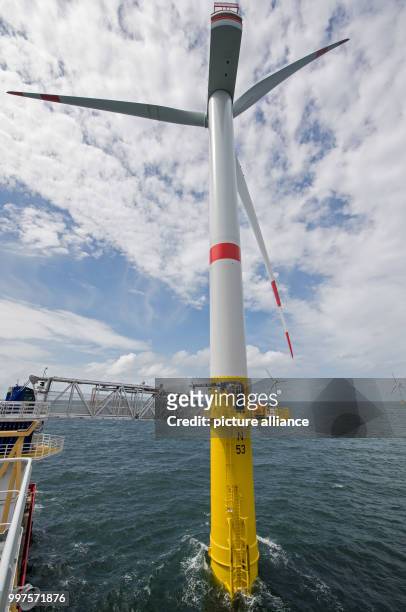 Technicians enter the lower work platform of a wind turbine of the offshore wind park "Nordsee 1" in front of the East Frisian island Spiekeroog,...
