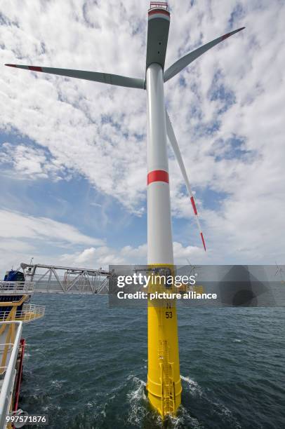 Technicians enter the lower work platform of a wind turbine of the offshore wind park "Nordsee 1" in front of the East Frisian island Spiekeroog,...