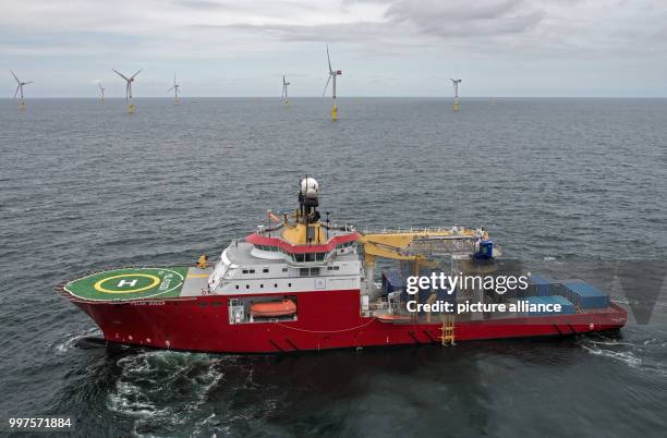 The service ship "Polar Queen" sails through the offshore wind park "Nordsee 1" in front of the East Frisian island Spiekeroog, Germany, 27 July...