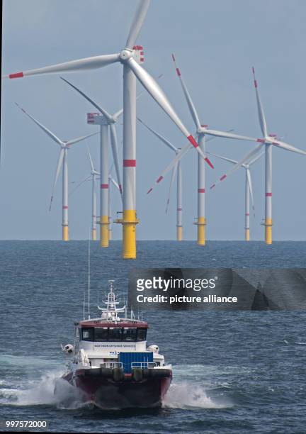 The boat "Detector" drives through the offshore wind park "Nordsee 1" in front of the East Frisian island Spiekeroog, Germany, 27 July 2017. At this...