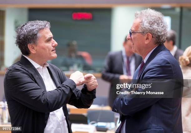 Greek Finance Minister Euclid Tsakalotos is talking with the Luxembourg Minister of Finance, Treasury, & Budget Pierre Gramegna during an EU EcoFin...