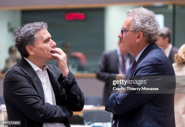 Greek Finance Minister Euclid Tsakalotos is talking with the Luxembourg Minister of Finance, Treasury, & Budget Pierre Gramegna during an EU EcoFin...