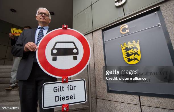 Juergen Resch, federal chairman of the German Environmental Organisation "Umwelthilfe" can be seen posing with a traffic sign reading "applies for...