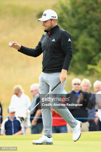 Tyrell Hatton of England reacts to his putt on hole seven during day two of the Aberdeen Standard Investments Scottish Open at Gullane Golf Course on...
