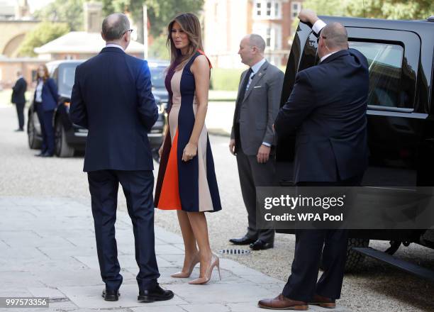 First Lady Melania Trump, is accompanied by Philip May, the husband of British Prime Minister Theresa May as she arrives to meet British military...