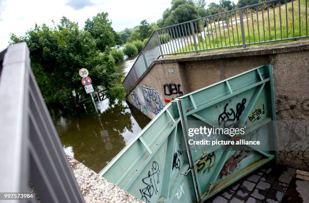 The water of the river Ihme has flooded the area, save for the courtyard protected by a gate in the district Ricklingen in Hanover, Germany, 28 July...