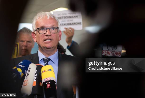 Juergen Resch, federal chairman of the German Environmental Organisation "Umwelthilfe" gives interviews while posing with a traffic sign reading...