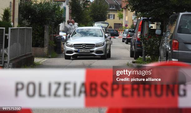 Barrier tape of the police can be seen on a street in Teningen, Germany, 28 July 2017. According to the police, a 52-year-old has killed a...
