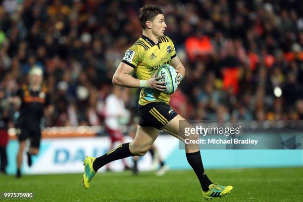 Hurricanes' Beauden Barrett runs the ball forward during the round 19 Super Rugby match between the Chiefs and the Hurricanes at Waikato Stadium on...
