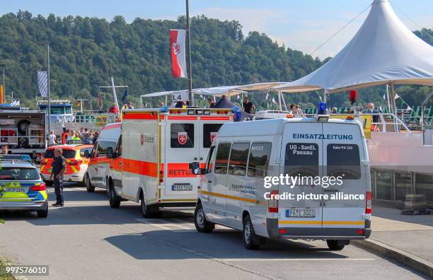 July 2018, Germany, Passau: Emergency vehicles standing on the banks of the Donau in front of a cruise ship. 40 passangers of the cruise ship have...