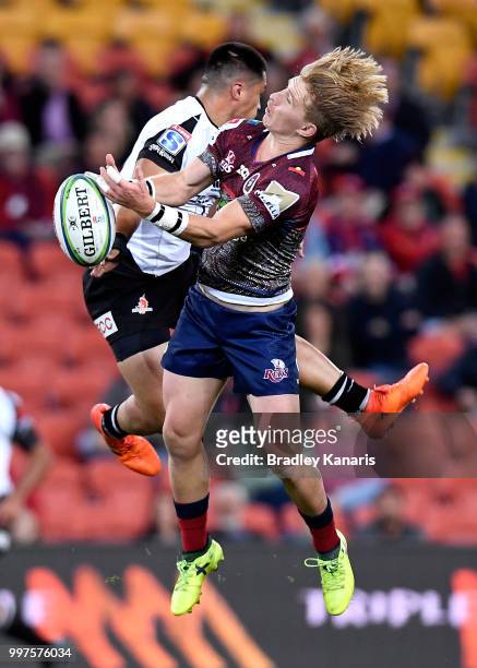 Tate McDermott of the Reds and Jason Emery of the Sunwolves compete for the ball during the round 19 Super Rugby match between the Reds and the...