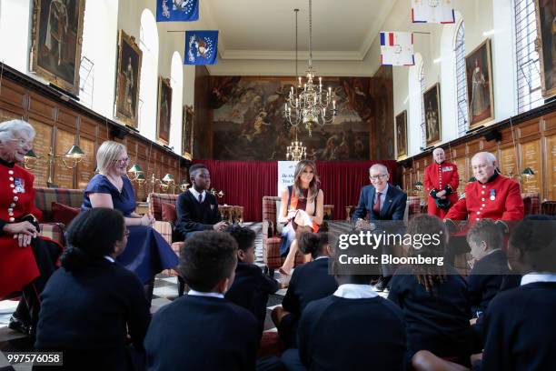 First Lady Melania Trump, center, and Philip May, husband of U.K. Prime Minister Theresa May, third right, meet with school children during a visit...