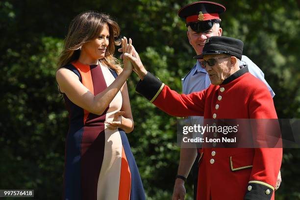 First Lady, Melania Trump, high-fives a Chelsea Pensioners as she tries her hand at bowls as she meets British Army veteransat Royal Hospital Chelsea...