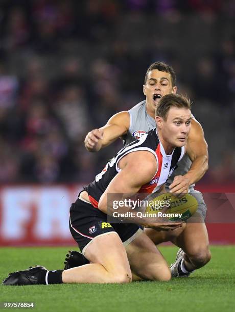 David Armitage of the Saints is tackled by Ed Curnow of the Blues during the round 17 AFL match between the St Kilda Saints and the Carlton Blues at...