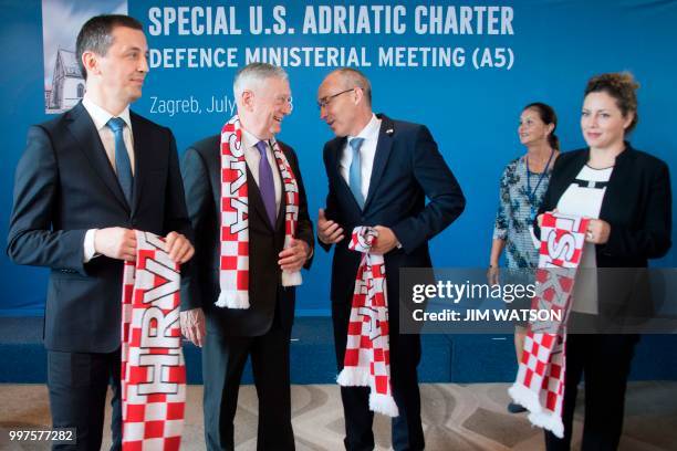 Secretary of Defense James Mattis has a Croatian football scarf given to him by Croatian Minister of Defense Damir Krsticevic as Montenegro Minister...