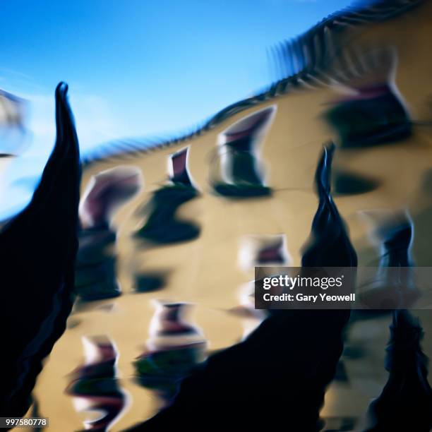 gondolas reflected in a venice canal - yeowell imagens e fotografias de stock