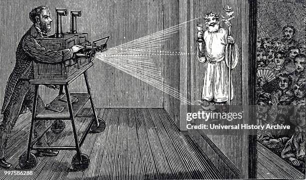 Engraving depicting an audience enjoying a magic lantern show. The apparatus here differs little from that of Kircher in the 17th century, consisting...