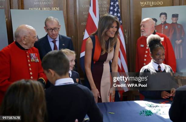 First Lady Melania Trump smiles as she meets British military veterans known as "Chelsea Pensioners" at Royal Hospital Chelsea on July 13, 2018 in...