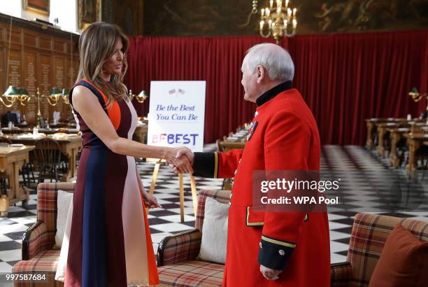 First Lady Melania Trump shakes hands with a British military veteran known as a "Chelsea Pensioner" at Royal Hospital Chelsea on July 13, 2018 in...