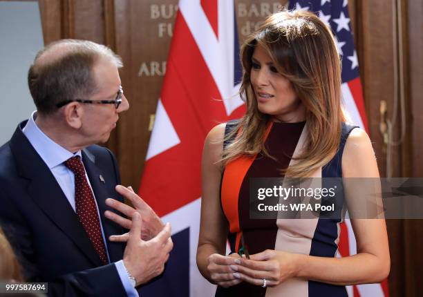 Philip May, the husband of British Prime Minister Theresa May, left, speaks with U.S. First Lady Melania Trump as she meets British military veterans...