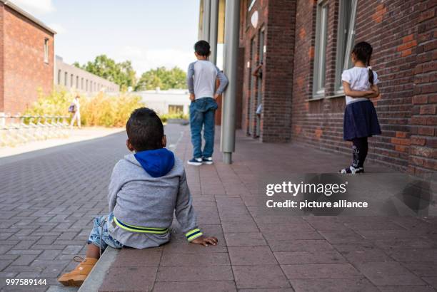 July 2018, Netherlands, Ter Apel: Three children, living as refugees at a reception centre, photographed at the central reception centre for asylum...