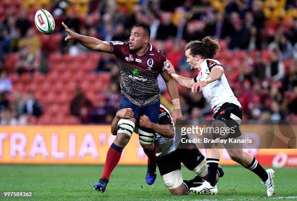 Caleb Timu of the Reds offloads during the round 19 Super Rugby match between the Reds and the Sunwolves at Suncorp Stadium on July 13, 2018 in...