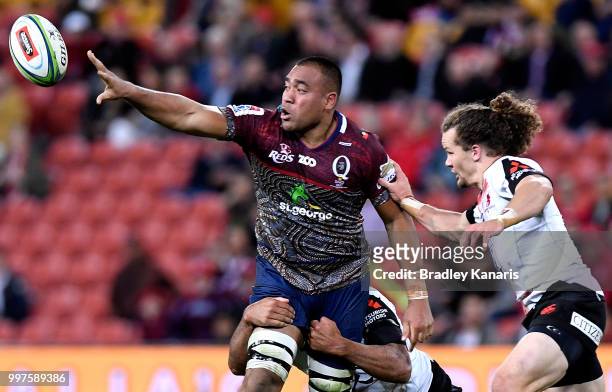 Caleb Timu of the Reds offloads during the round 19 Super Rugby match between the Reds and the Sunwolves at Suncorp Stadium on July 13, 2018 in...