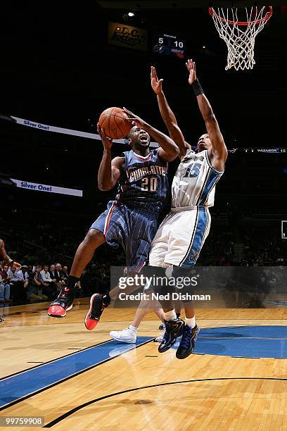 Raymond Felton of the Charlotte Bobcats puts a shot up against Randy Foye of the Washington Wizards during the game on March 23, 2010 at the Verizon...