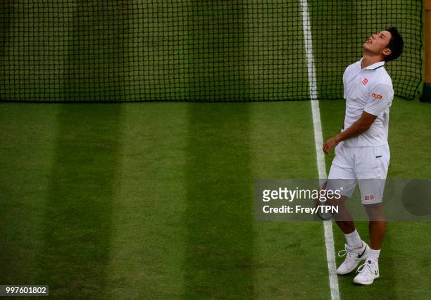 Kei Nishikori of Japan celebrates after beating Ernests Gulbis of Latvia in the fourth round of the gentlemen's singles at the All England Lawn...
