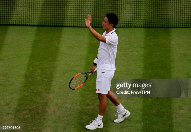 Kei Nishikori of Japan celebrates after beating Ernests Gulbis of Latvia in the fourth round of the gentlemen's singles at the All England Lawn...