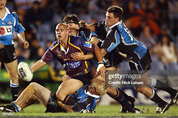 Corey Parker of the Broncos offloads under pressure from the Sharks defence during the NRL qualifying final between the Sharks and the Brisbane...
