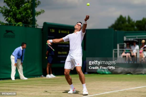 Milos Raonic of Canada in action against Mackenzie McDonald of the United States in the fourth round of the gentlemen's singles at the All England...