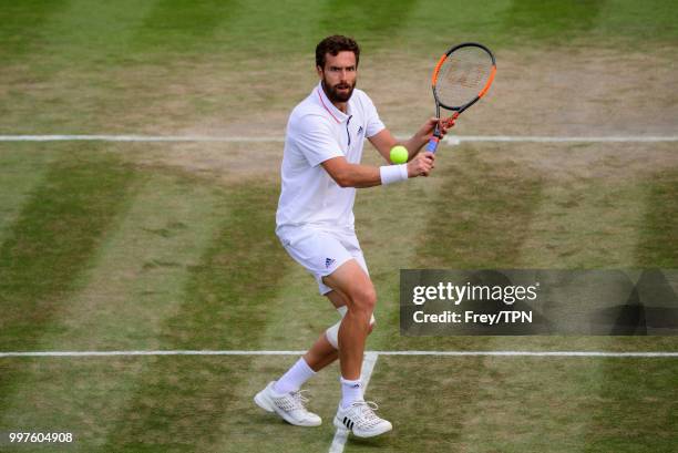 Ernests Gulbis of Latvia in action against Kei Nishikori of Japan in the fourth round of the gentlemen's singles at the All England Lawn Tennis and...