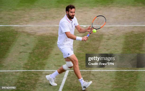 Ernests Gulbis of Latvia in action against Kei Nishikori of Japan in the fourth round of the gentlemen's singles at the All England Lawn Tennis and...