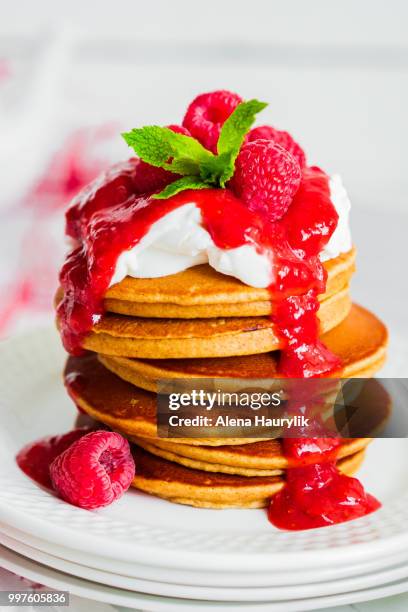pancakes with raspberry sauce on white background - raspberry sauce stock pictures, royalty-free photos & images