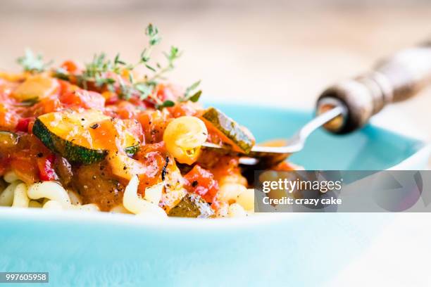 curly pasta with tomato sauce - tomato pasta stock pictures, royalty-free photos & images