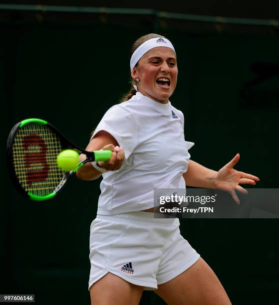 Jelena Ostapenko of Latvia in action against Aliaksandra Sasnovich of Belarus in the fourth round of the ladies' singles at the All England Lawn...