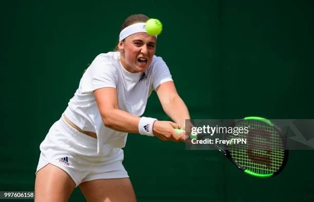 Jelena Ostapenko of Latvia in action against Aliaksandra Sasnovich of Belarus in the fourth round of the ladies' singles at the All England Lawn...