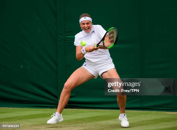 Jelena Ostapenko of Latvia in action against Aliaksandra Sasnovich of Belarus in the fourth round of the ladies' singles at the All England Lawn...