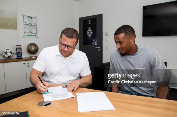 Director of Sport Max Eberl and Alassane Plea sign a new contract for Borussia Moenchengladbach at Borussia-Park on July 12, 2018 in...