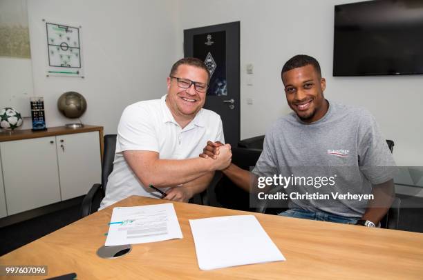 Director of Sport Max Eberl pose with Alassane Plea after he signs a new contract for Borussia Moenchengladbach at Borussia-Park on July 12, 2018 in...